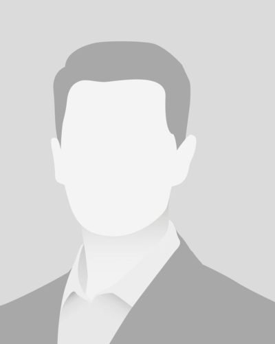 close-up-young-successful-man-smiling-camera-standing-casual-outfit-against-blue-background